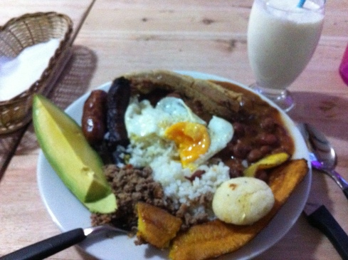 Bandeja paisas is a common dish from Medellin, Colombia. The food from that part of the country is what's known around the world as Colombian food.  We got rice, red beans, an egg, platanos, a small arepa, aguacate, hella chicarones, chorizo, and some other meat too.